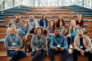 multiracial-group-of-happy-business-seminar-attendees-at-convention-center-looking-at-camera-.jpg